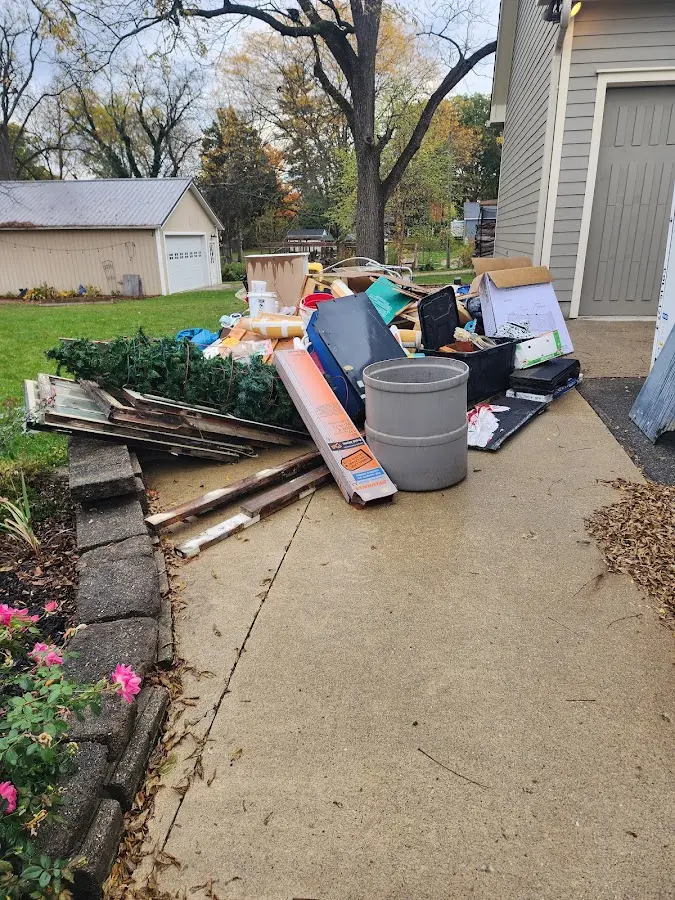 Dumpster being loaded with debris for Estate Cleanout Dumpster Rental in Pound Ridge